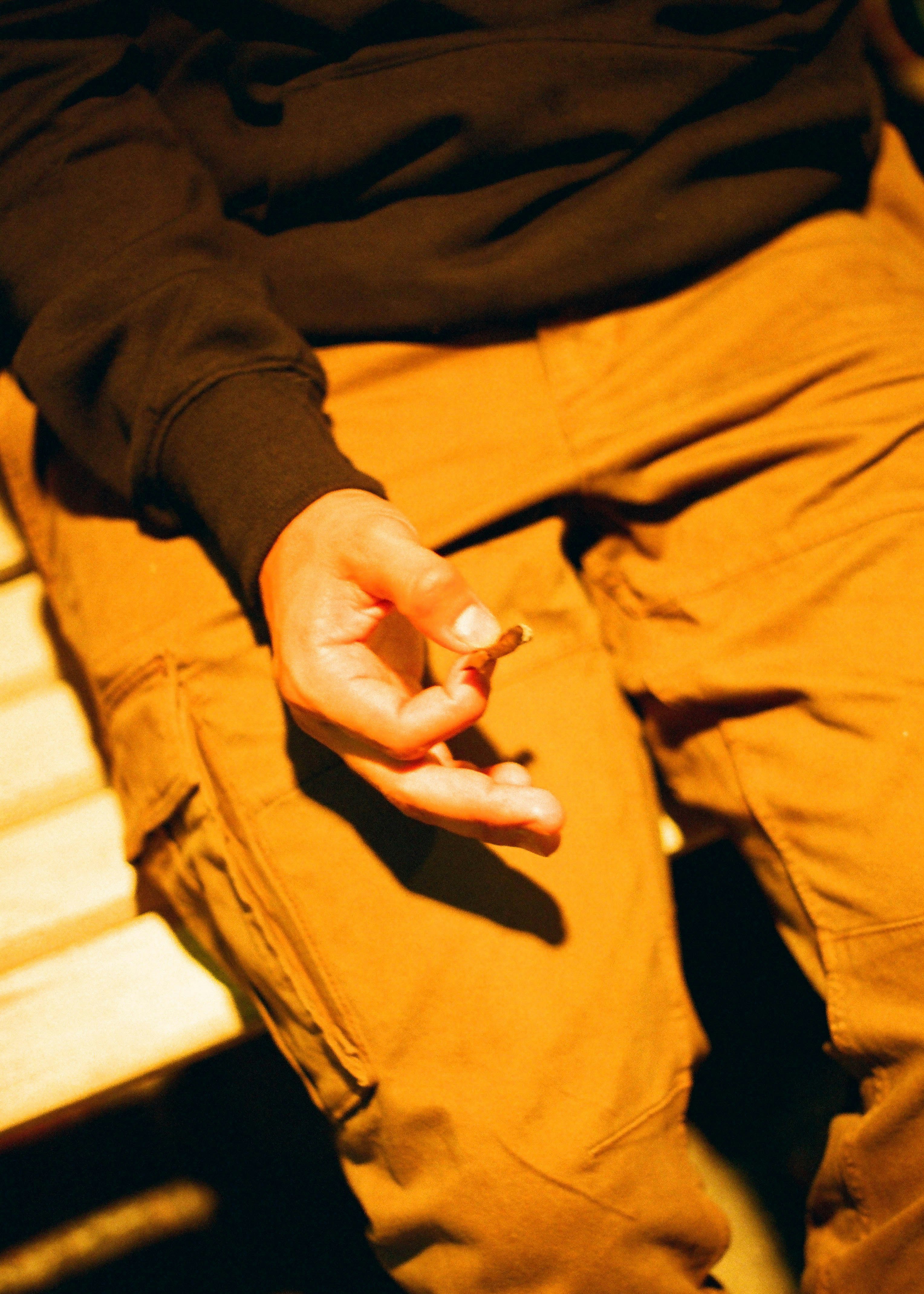 person in brown pants and black long sleeve shirt